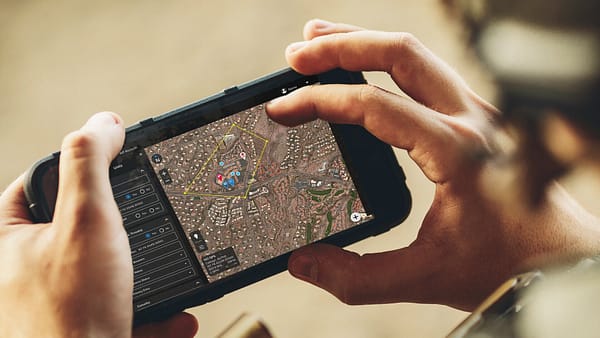 Android phone in users hands with screen displaying Squire Solutions app