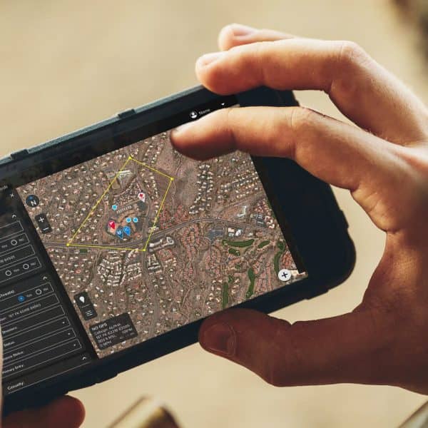 Android phone in users hands with screen displaying Squire Solutions app