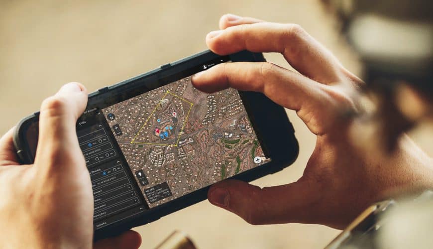 Android phone in users hands with screen displaying Squire Solutions app